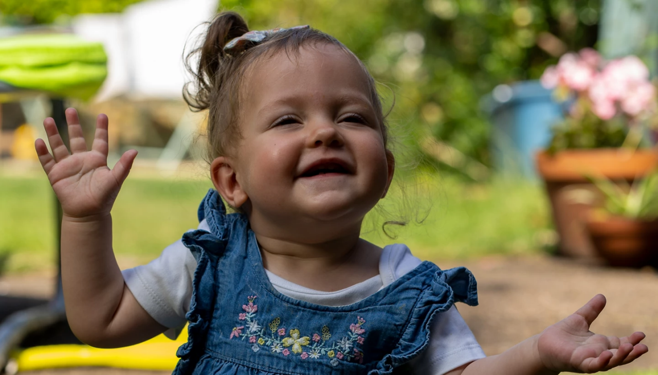Toddler smiling in the garden